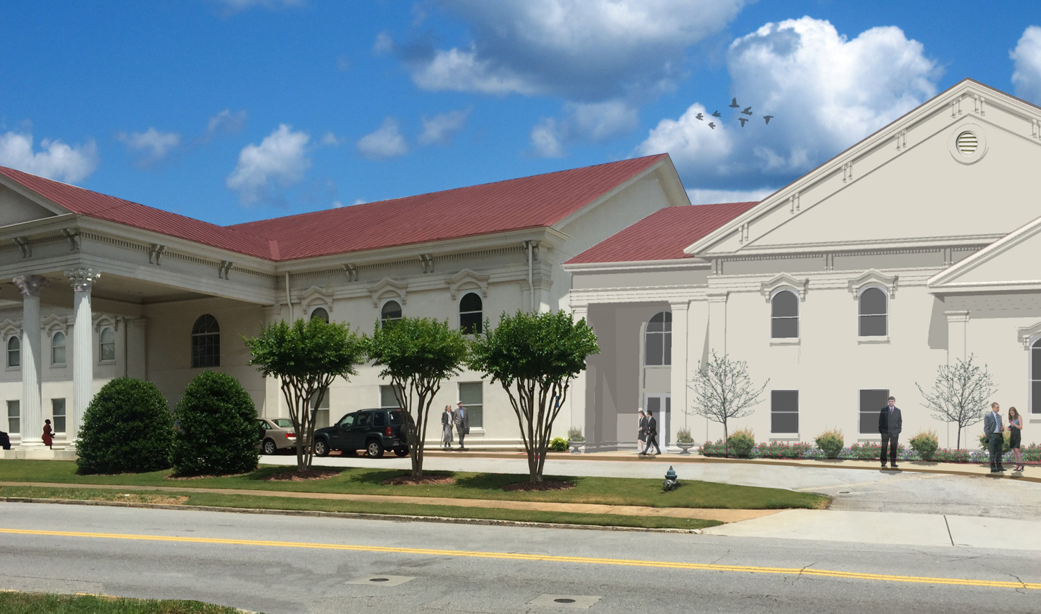 A large white building with columns and a red roof sits under a cloudy sky. People walk outside; cars are parked near trees and shrubs.