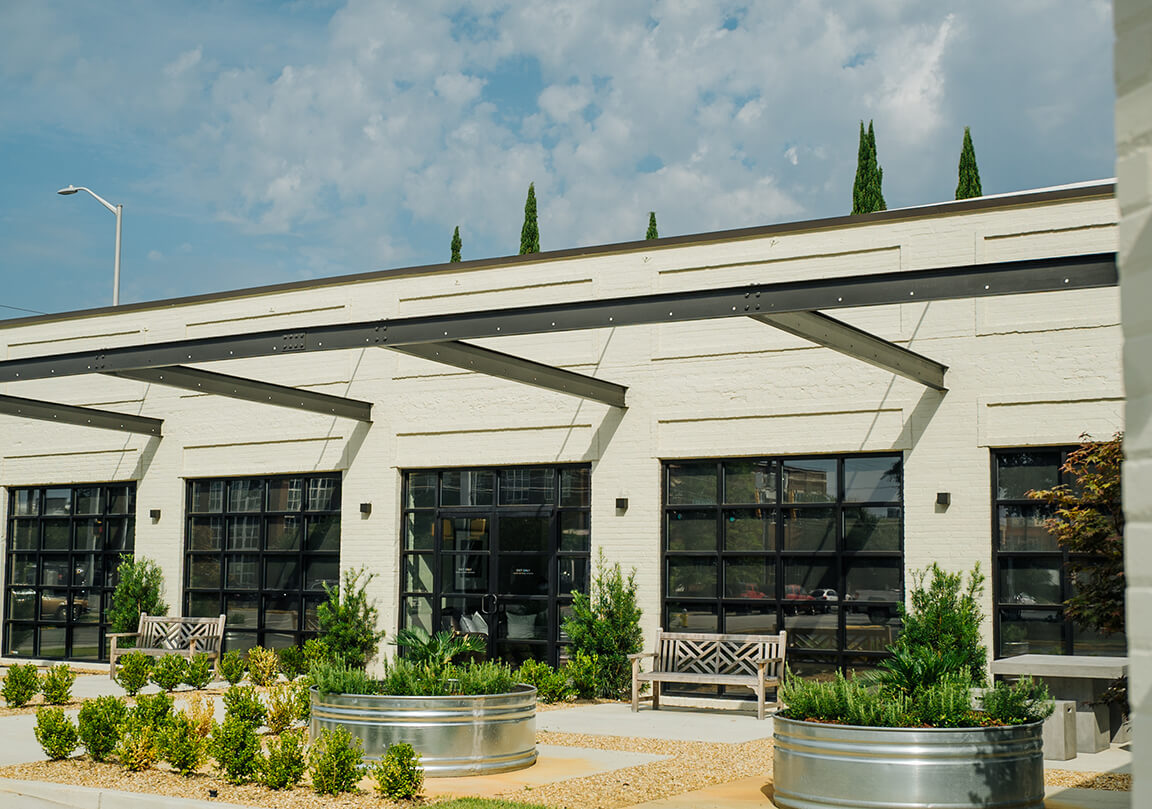 patio area of the Adams ADR building with plants, benches, and tables