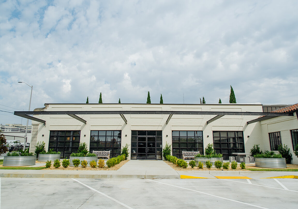 a straight facing view of front doors to the Adams ADR building, with patios on either side of the doors