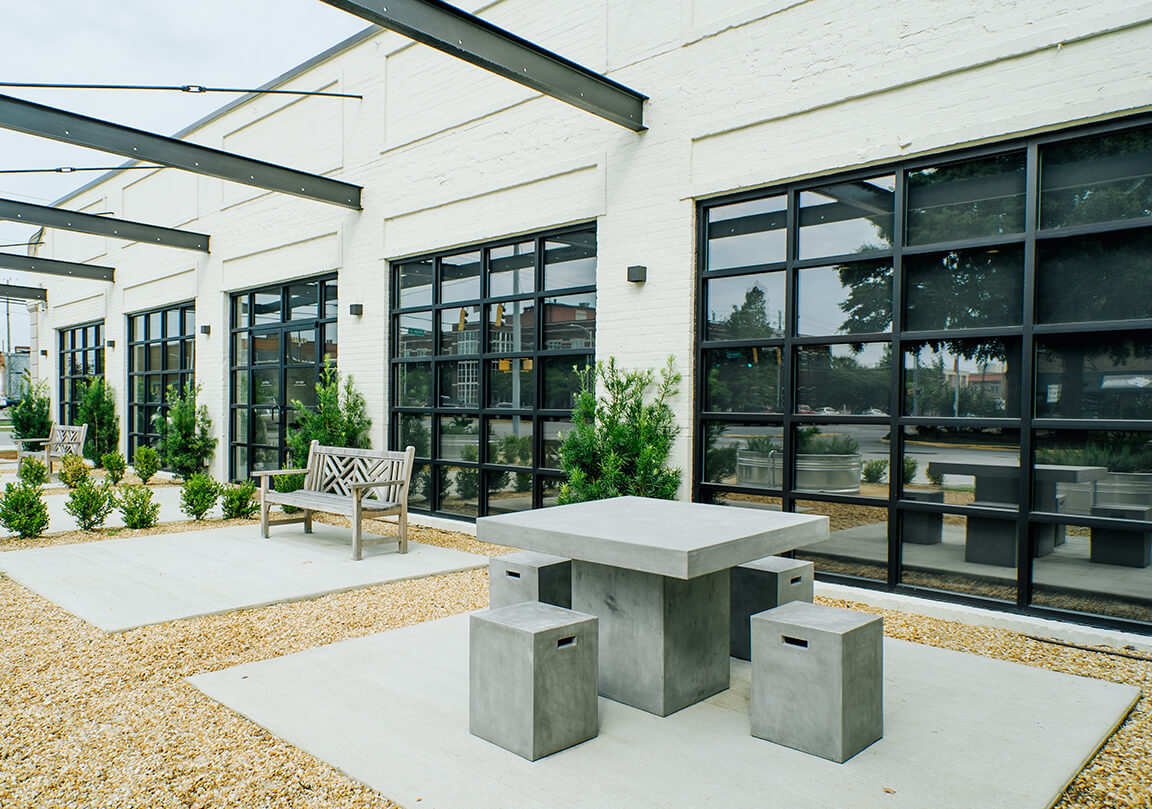 brick patio table with brick seating and wooden benches outside