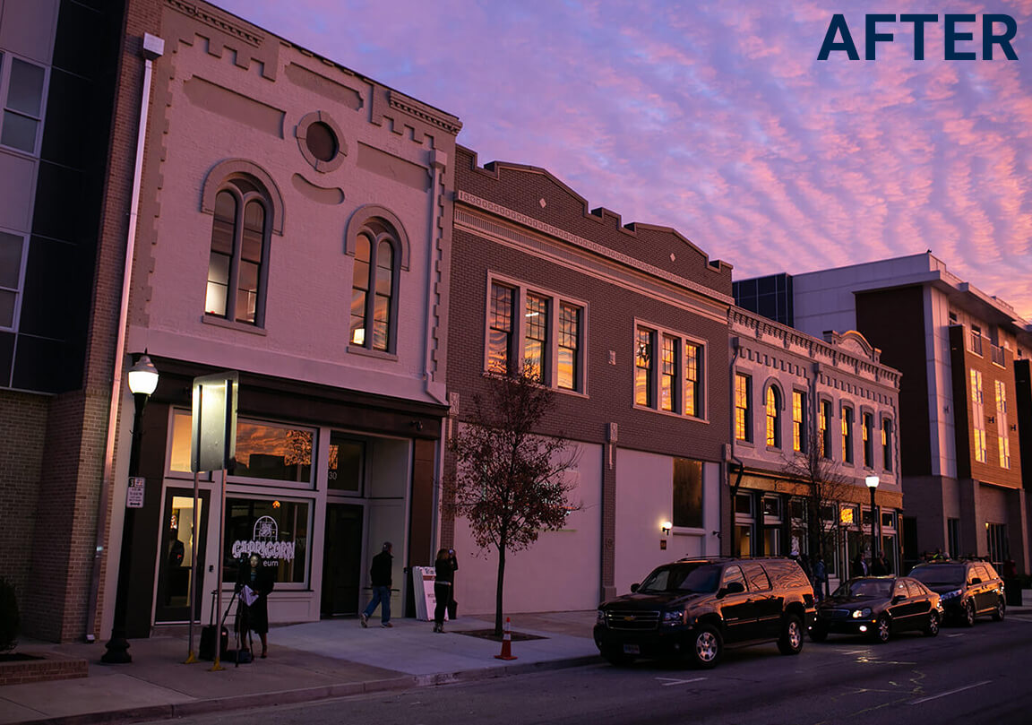 A street scene at sunset shows renovated historic brick buildings, parked cars, a few people walking, and an AFTER label in the corner.